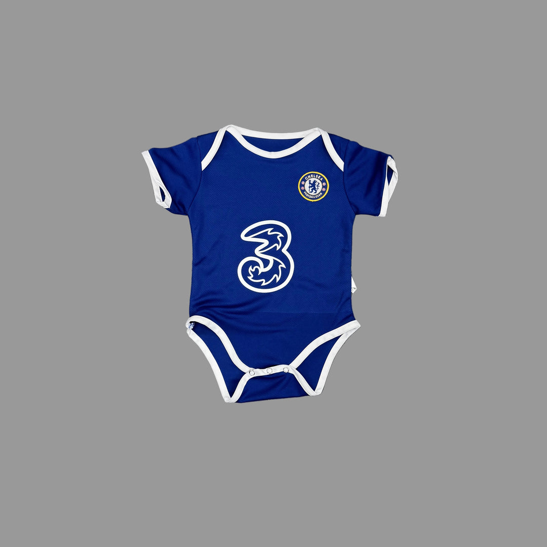 A royal blue short-sleeve baby bodysuit with white trim, featuring the Chelsea FC crest on the left chest and a large white number 3 on the front, laid flat on a gray concrete floor.